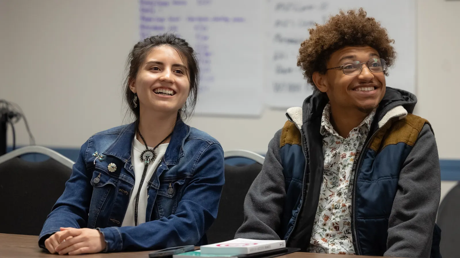Two young Wisconsinites smile during a Badger Youth Organizing meeting.